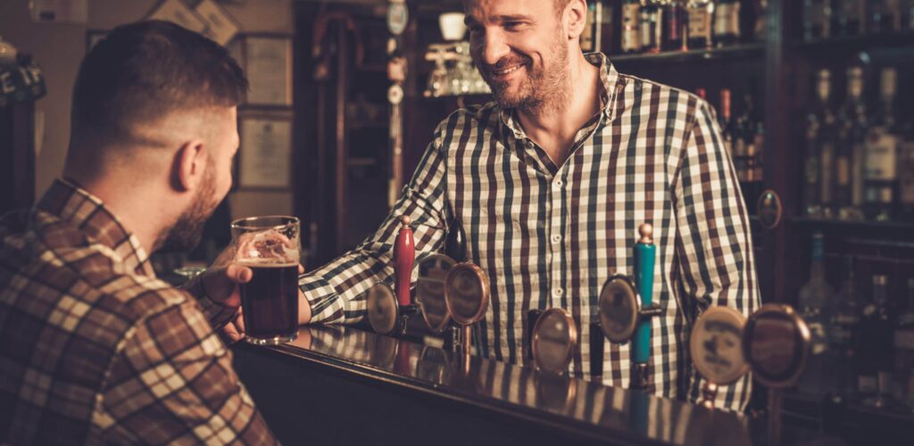 A bartender serving a drink in an Irish pub - Nejron